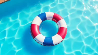 Red White and Blue Lifebuoy Floating in Swimming Pool