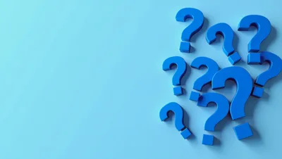 Blue Question Marks Scattered On A Light Blue Background