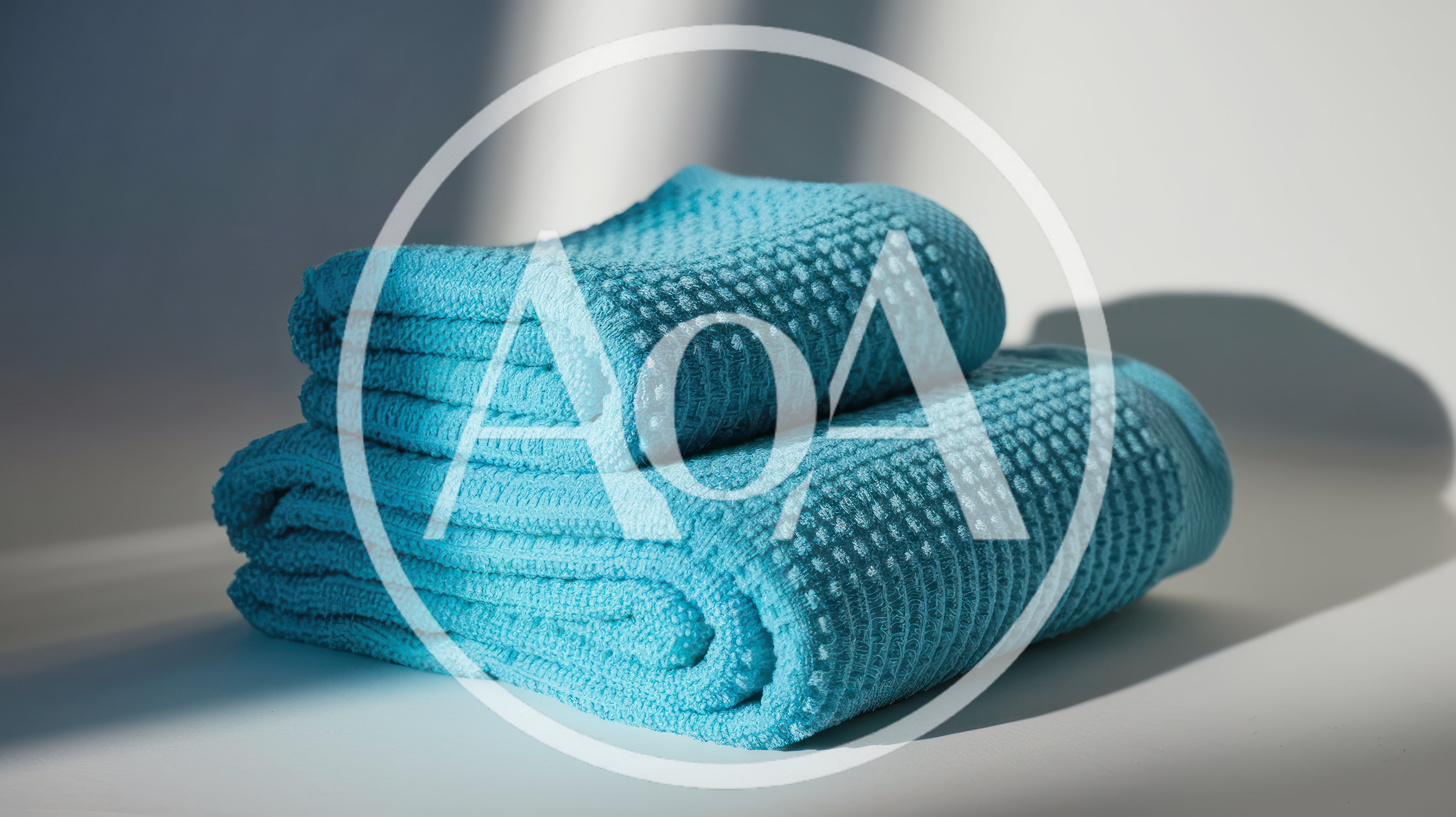 Two Folded Blue Textured Bath Towels