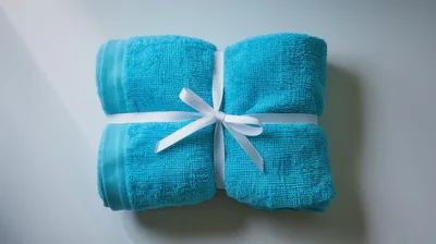 Folded Blue Towel Tied With White Ribbon