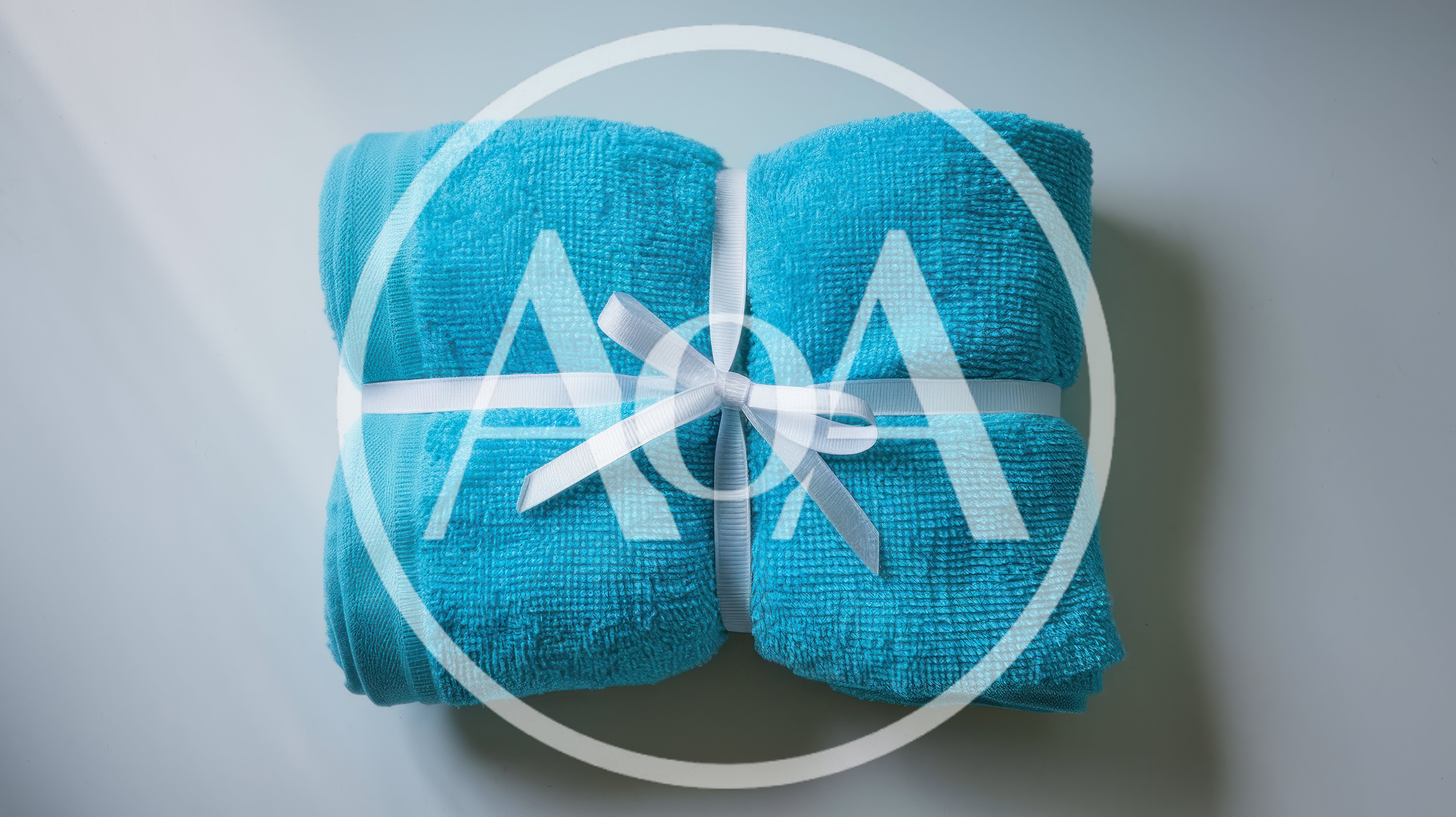 Folded Blue Towel Tied With White Ribbon
