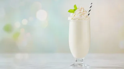 Vanilla Milkshake With Whipped Cream And Mint Garnish