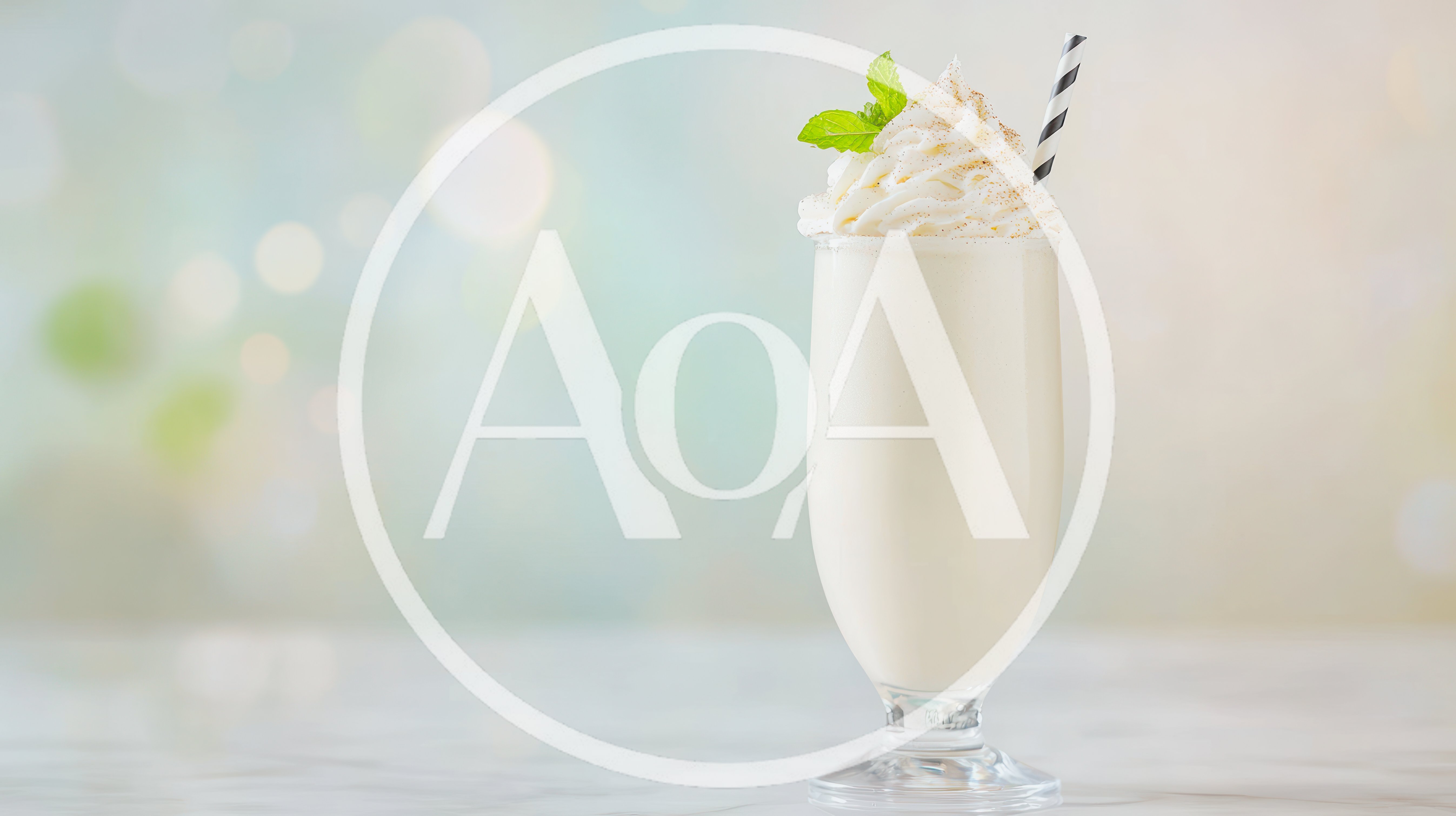 Vanilla Milkshake With Whipped Cream And Mint Garnish