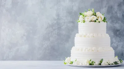 Three Tiered White Wedding Cake With Floral Topper