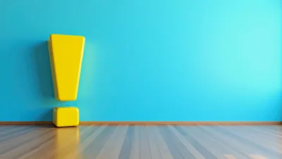 Yellow Exclamation Mark Symbol Against Blue Wall