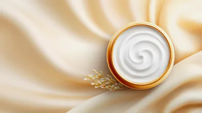 White Face Cream In A Gold Jar On Silk