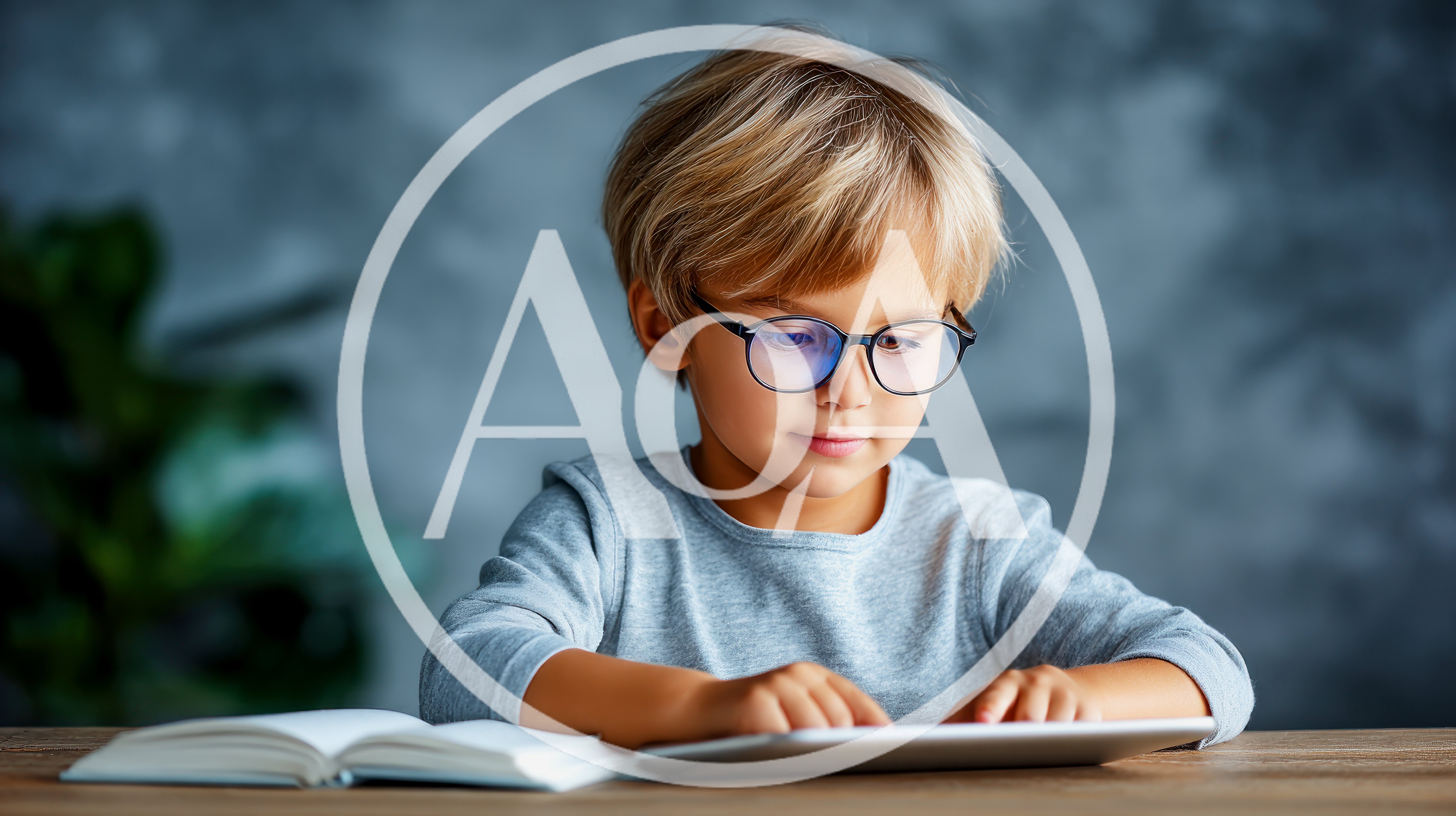 Young Boy Wearing Glasses Using A Digital Tablet
