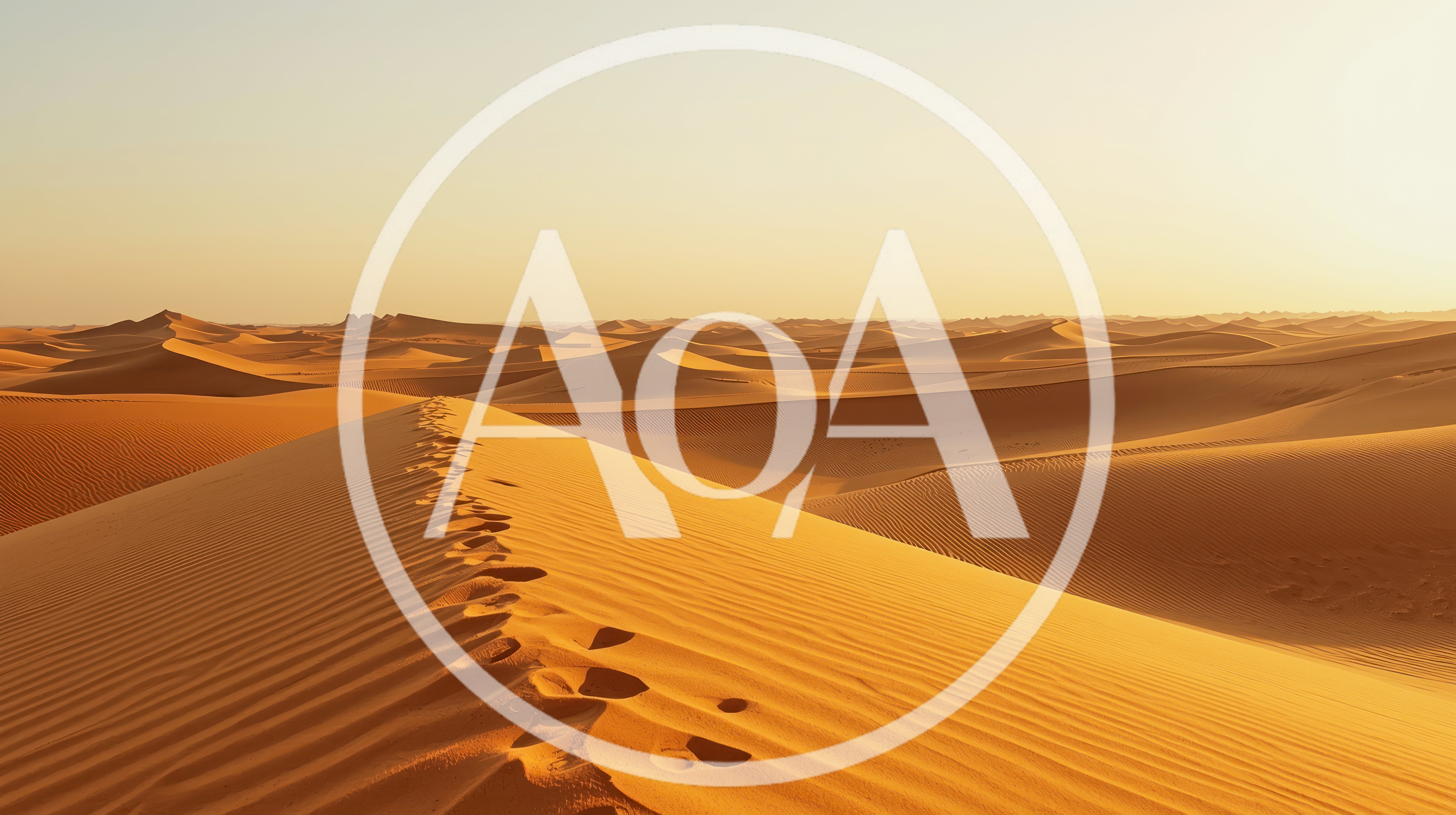 Footprints Leading Across A Vast Golden Sand Dune