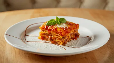 Gourmet Lasagna Serving On A White Plate
