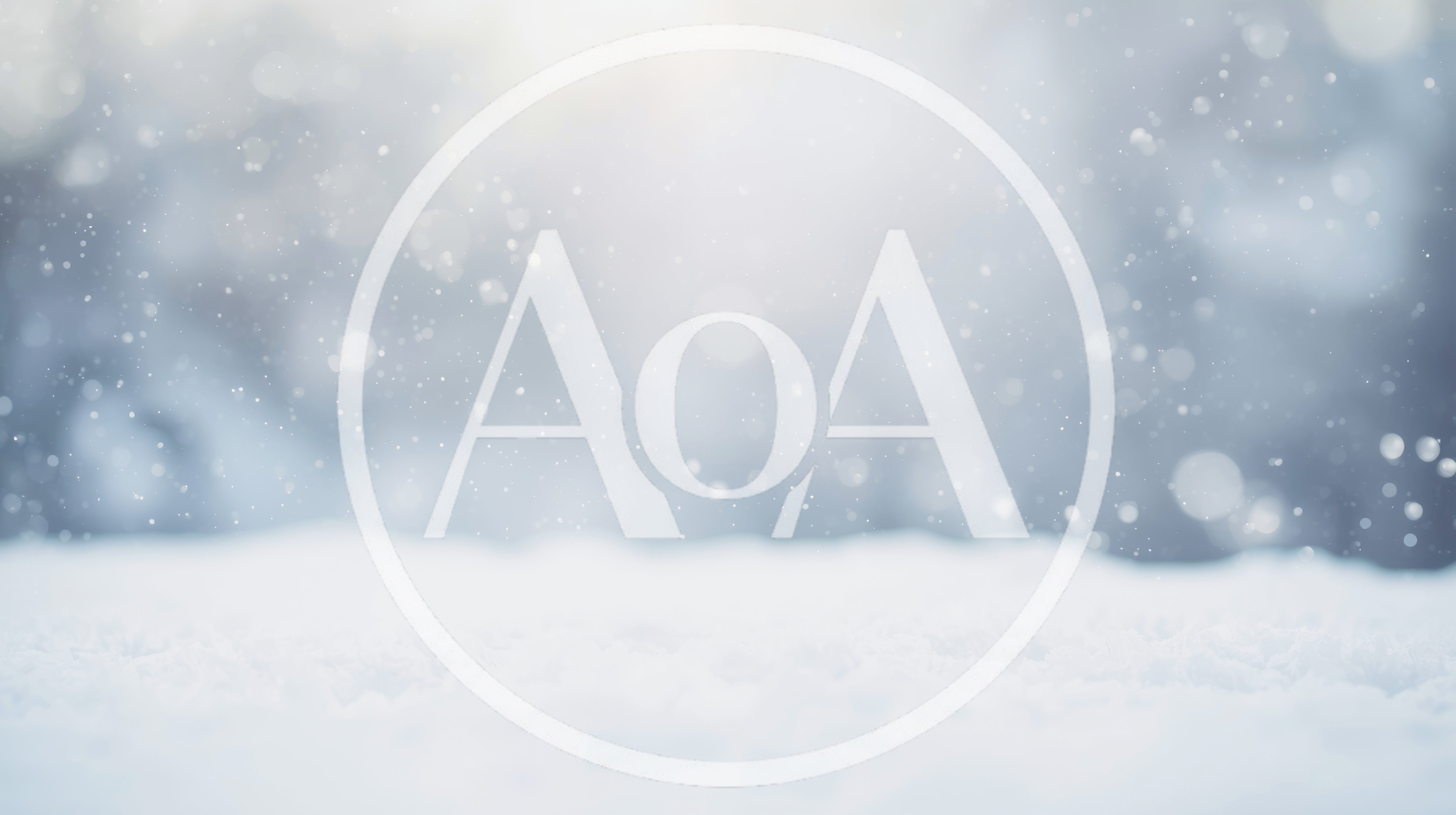 Soft Snow Falling Over A Blurred Winter Forest Background