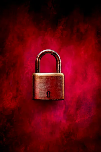 Brass Padlock Against A Vibrant Red Smoky Background