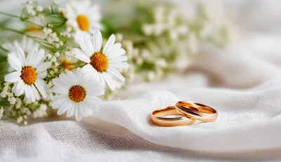 Two Gold Wedding Rings With Daisy Flowers
