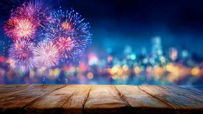 Rustic Wooden Table Overlooking Vibrant City Fireworks Display