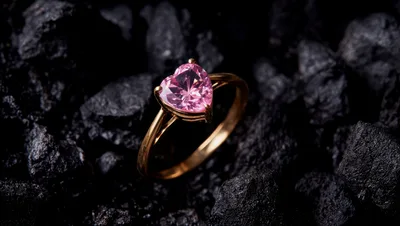 Gold Ring With Pink Heart Shaped Gemstone On Coal