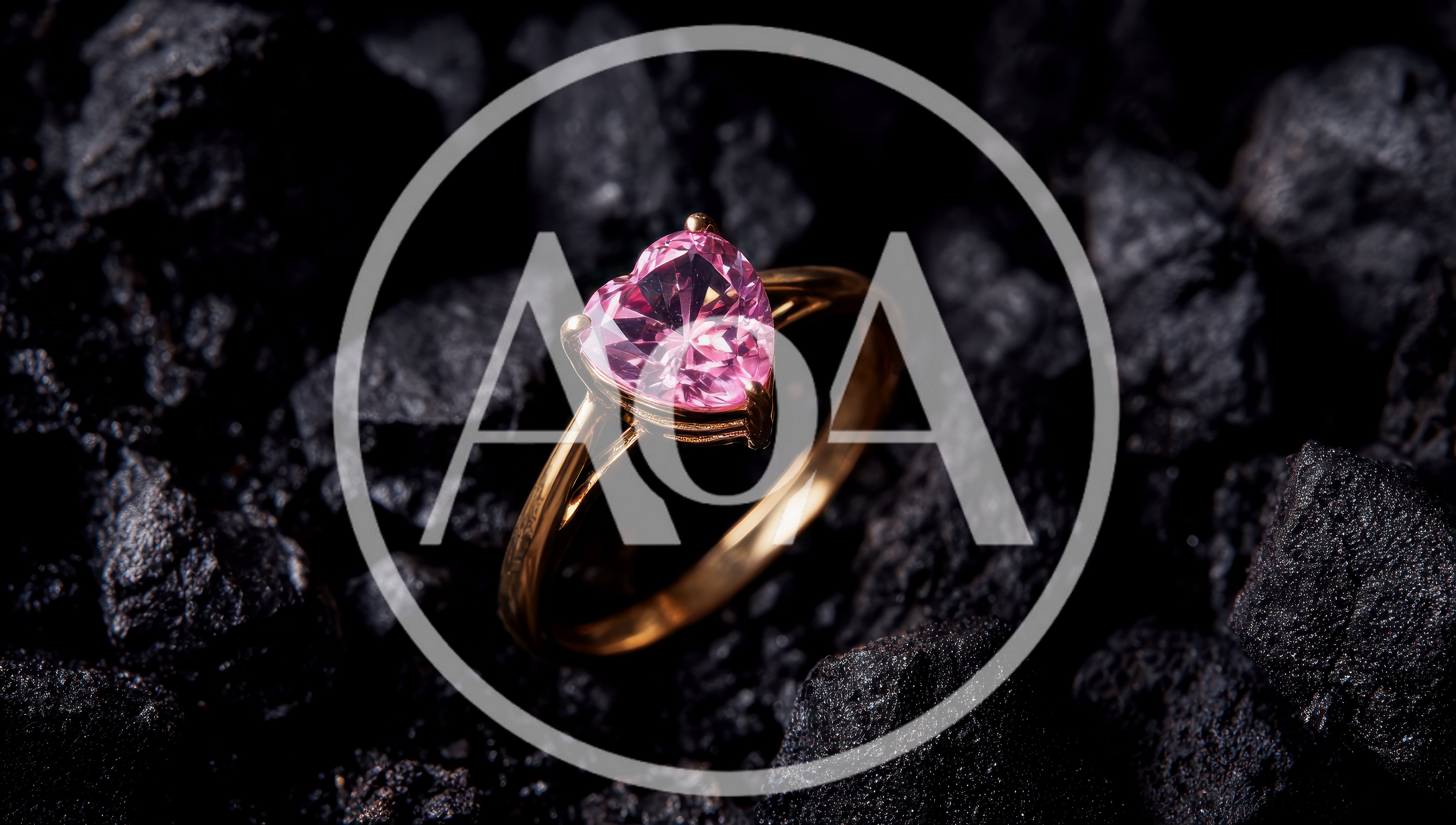 Gold Ring With Pink Heart Shaped Gemstone On Coal