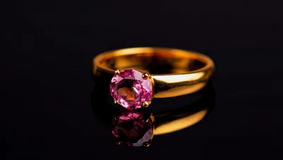 Gold Ring With Pink Gemstone On Black Background