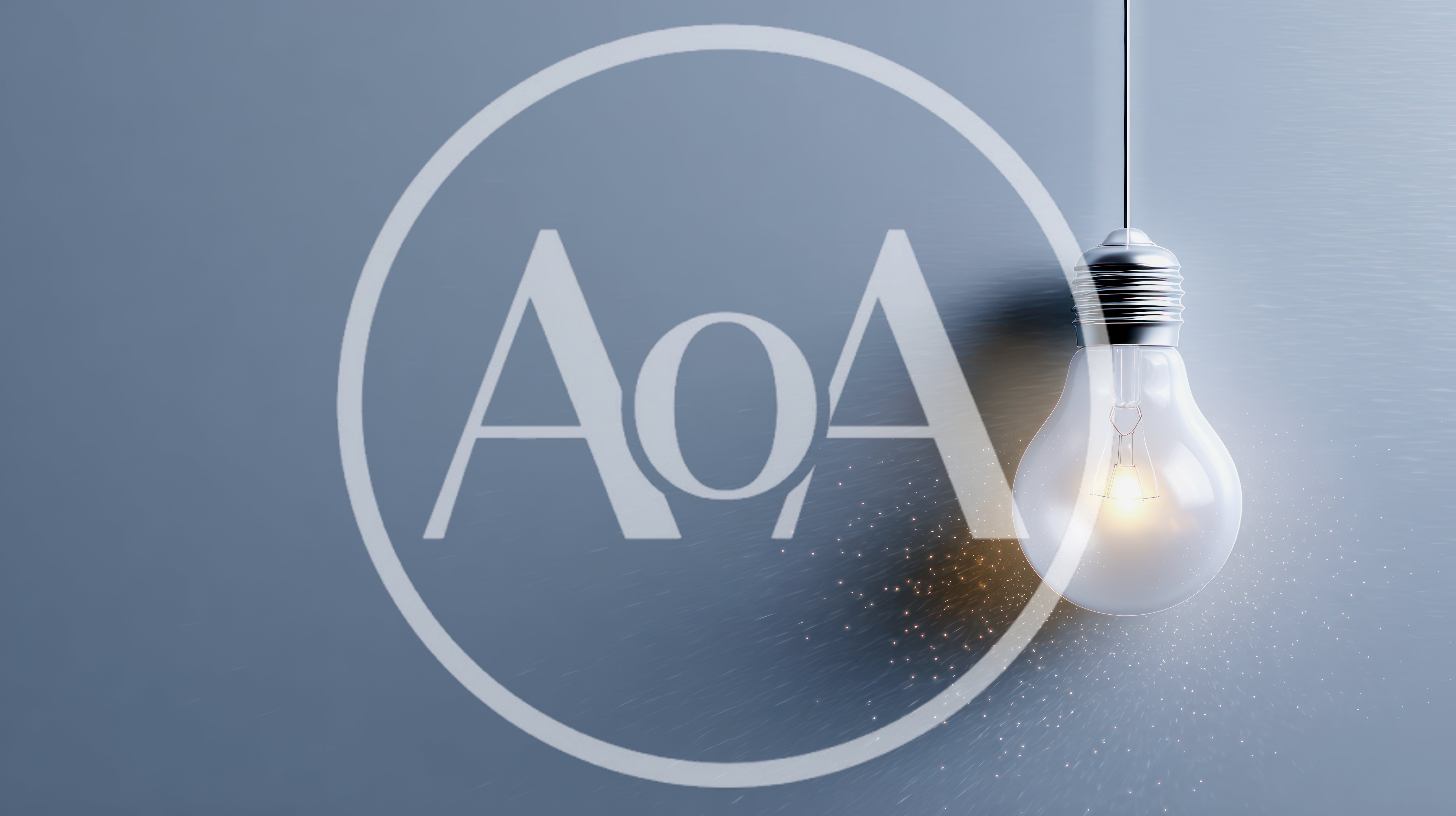 Glowing Light Bulb Hanging Against A Grey Background