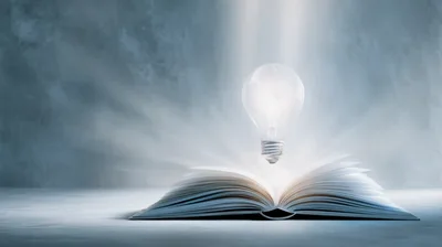 Glowing Light Bulb Floating Above Open Book