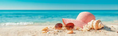 Pink Sun Hat and Sunglasses on Sandy Beach