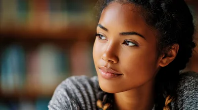 Young Woman Looking Away Thoughtfully In A Library