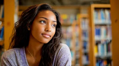 Young Woman Thinking In A Library Setting