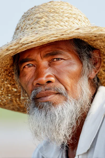 Portrait Of An Elderly Asian Farmer Wearing Straw Hat