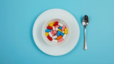 Bowl Of Assorted Colorful Pills On A Plate