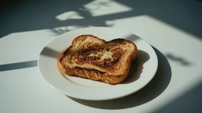 Single Slice Of Toasted Brioche Bread On White Plate