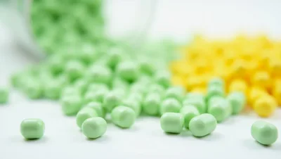 Green And Yellow Pills Spilled From A Bottle