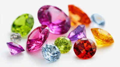 Collection Of Colorful Faceted Gemstones On White Background
