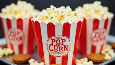 Three Red and White Striped Popcorn Buckets