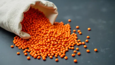 Red Lentils Spilling From A Fabric Bag