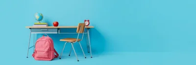 School Desk With Backpack And Supplies On Blue Background