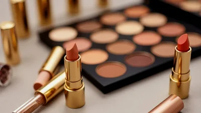 Makeup Palette and Lipsticks on Neutral Background