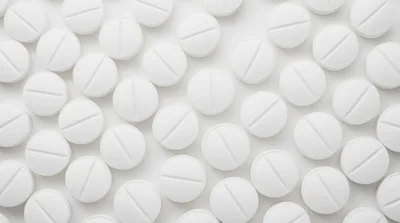 Top View Of White Round Pills On White Background