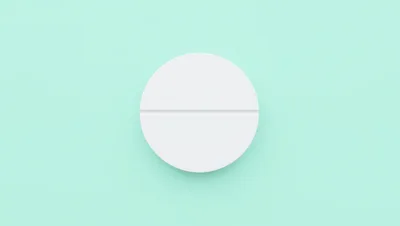 White Medical Pill On Pastel Green Background