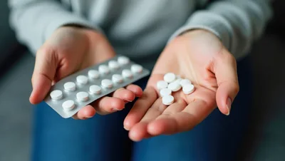 Person Holding Medication Pills And Blister Pack