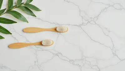 Two Bamboo Toothbrushes on Marble Surface