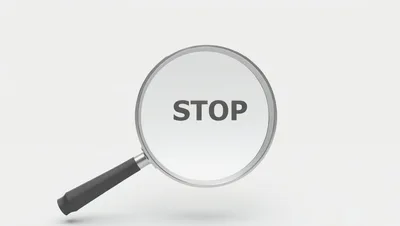 Magnifying Glass Focusing On The Word Stop