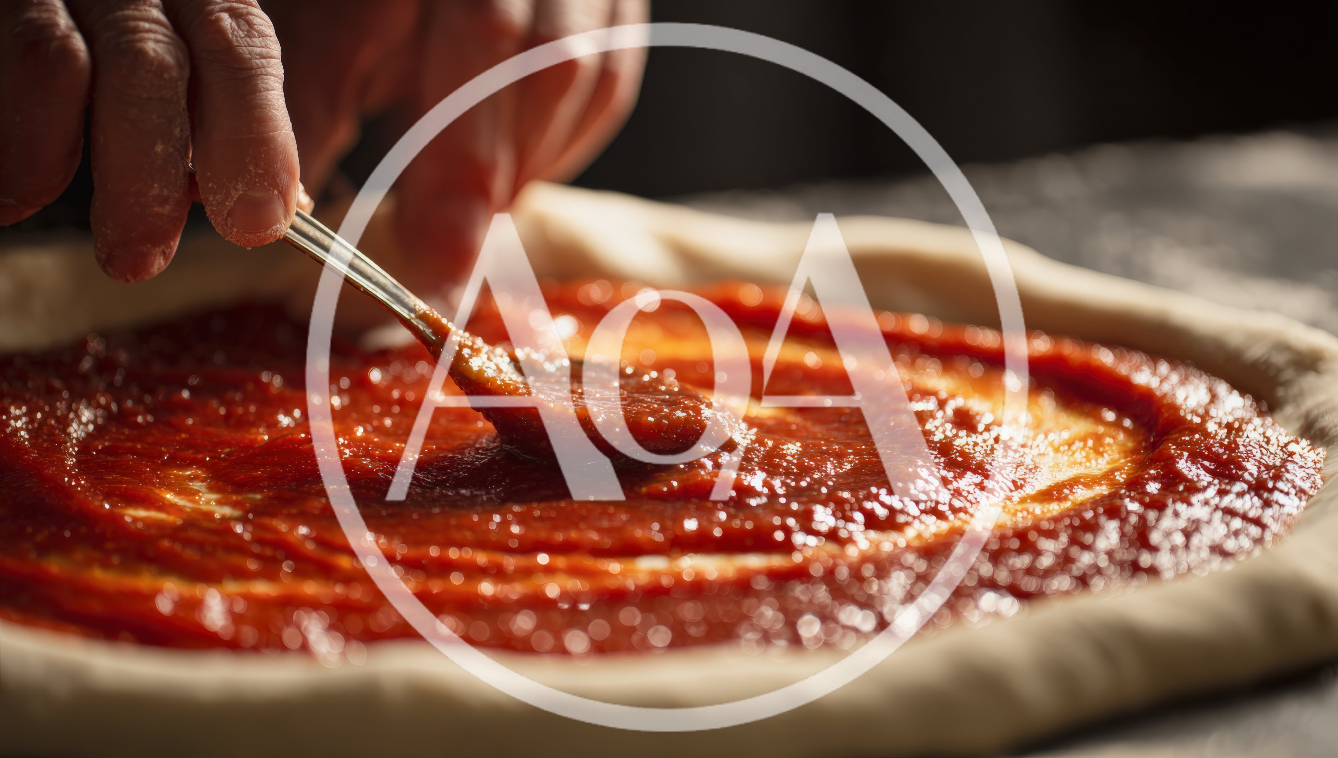 Chef Spreading Tomato Sauce On Pizza Dough