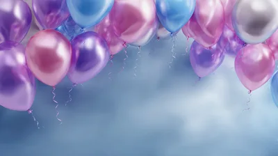 Floating Metallic Balloons Against A Soft Blue Background