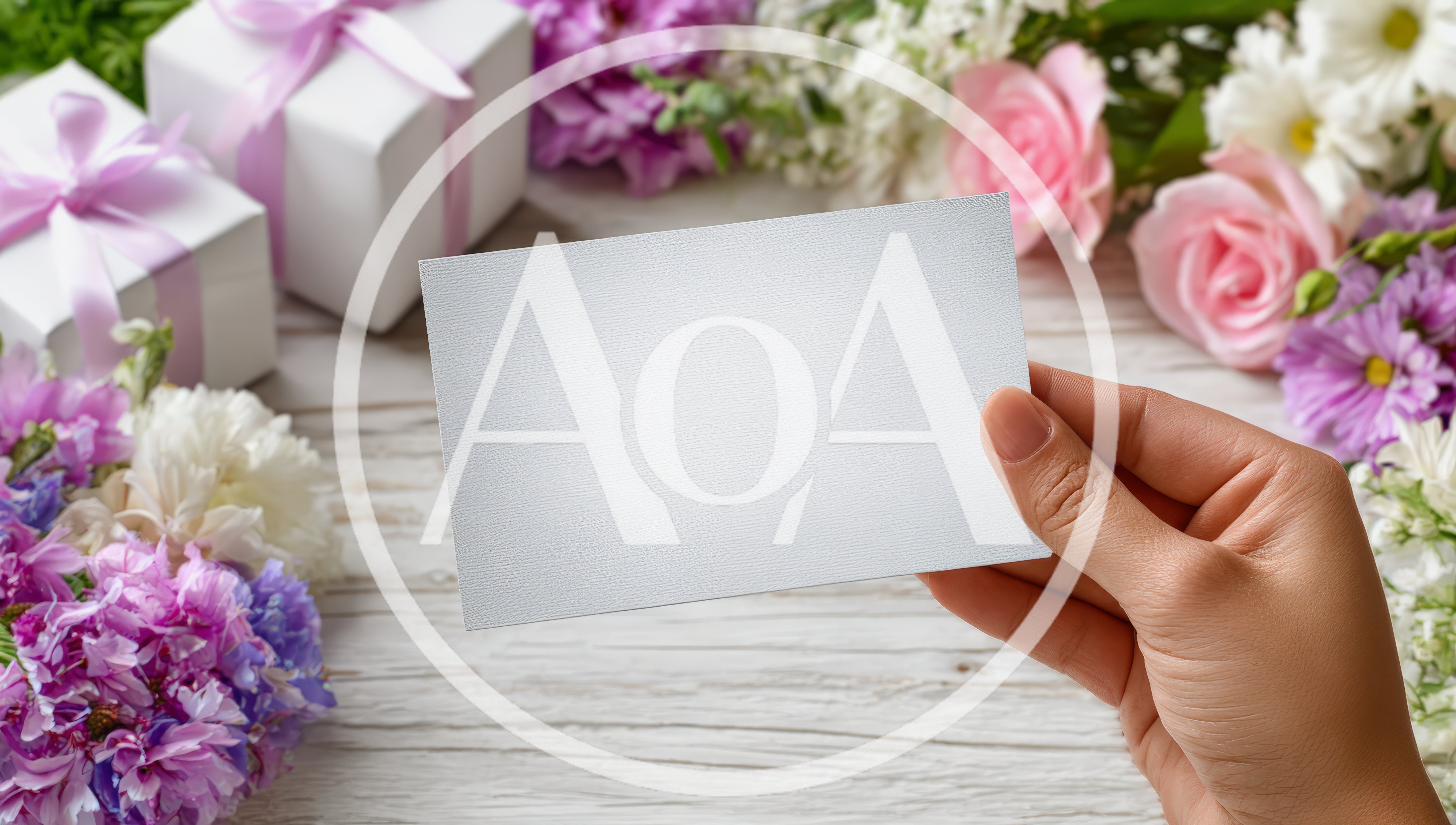 Hand Holding Blank Card Over Floral Background