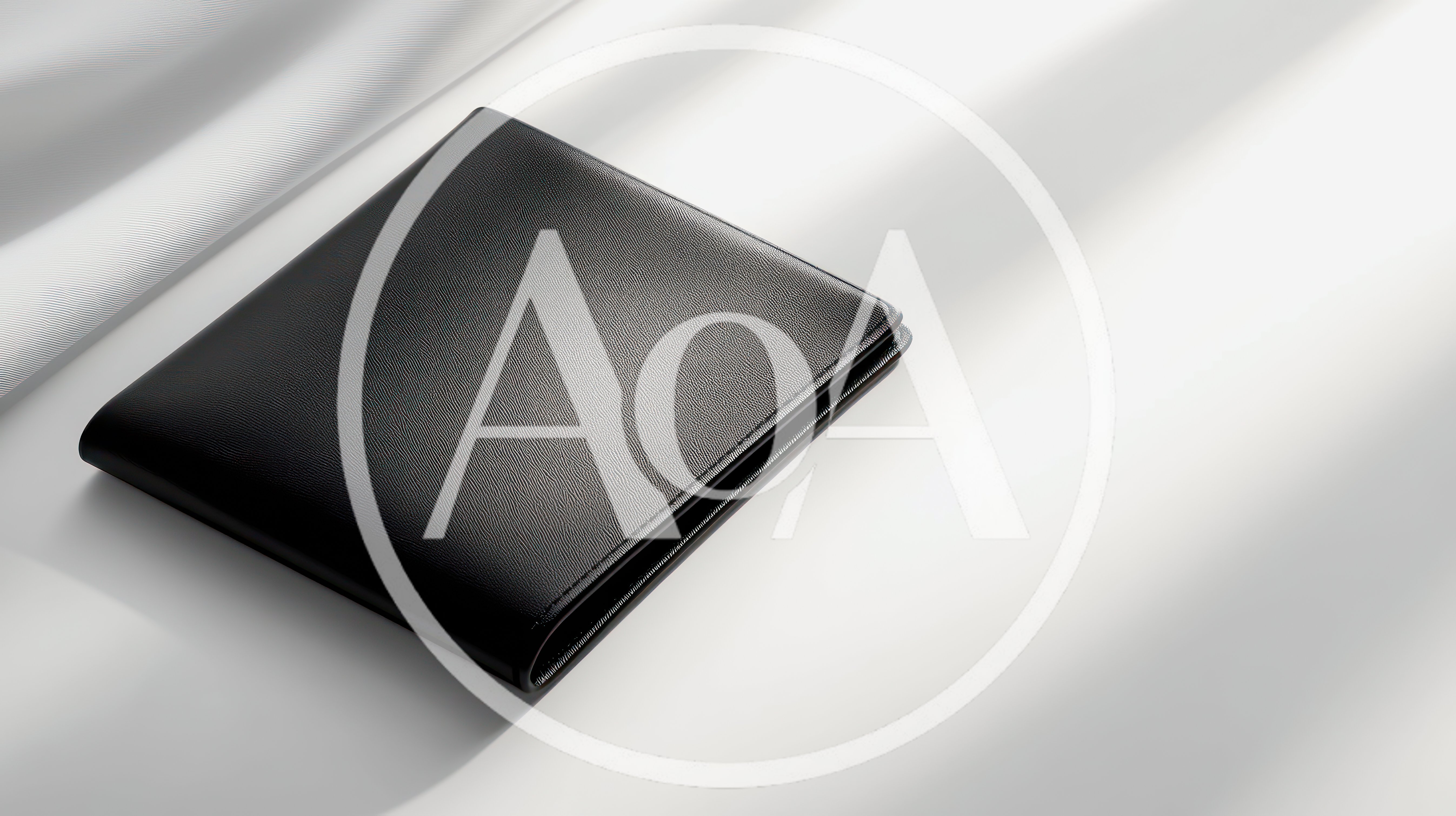 Black Leather Wallet Resting On White Silk Fabric