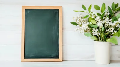 Blank Chalkboard With White Flowers In A Vase