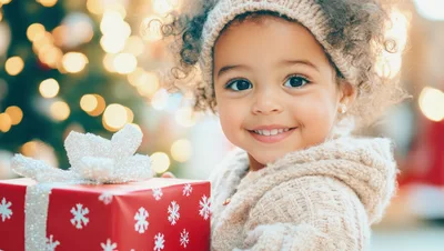 Happy Toddler Holding A Christmas Gift