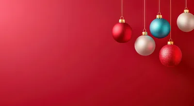 Hanging Christmas Ornaments Against A Red Background