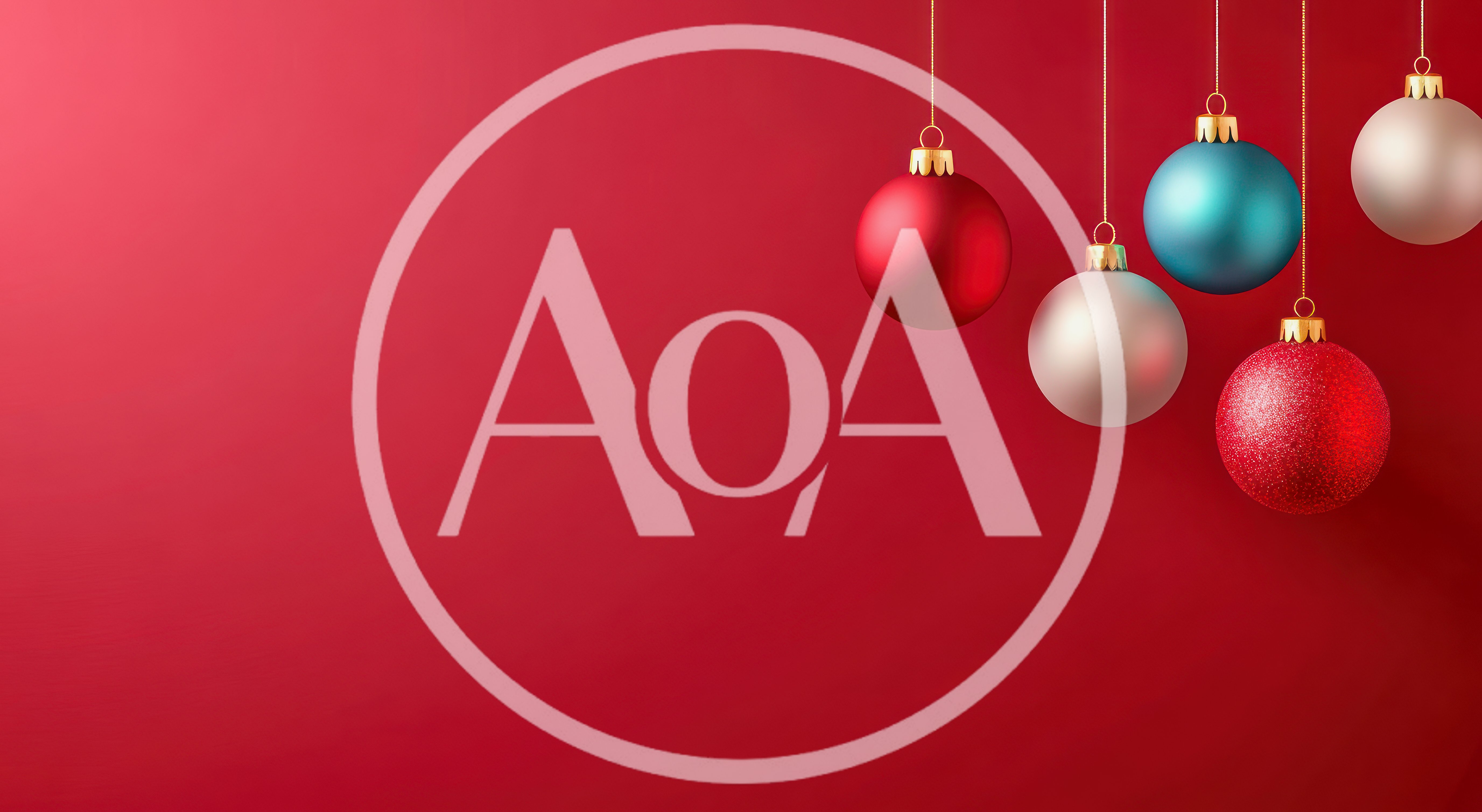 Hanging Christmas Ornaments Against A Red Background