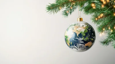 Earth Globe Christmas Ornament Hanging On Pine Branch