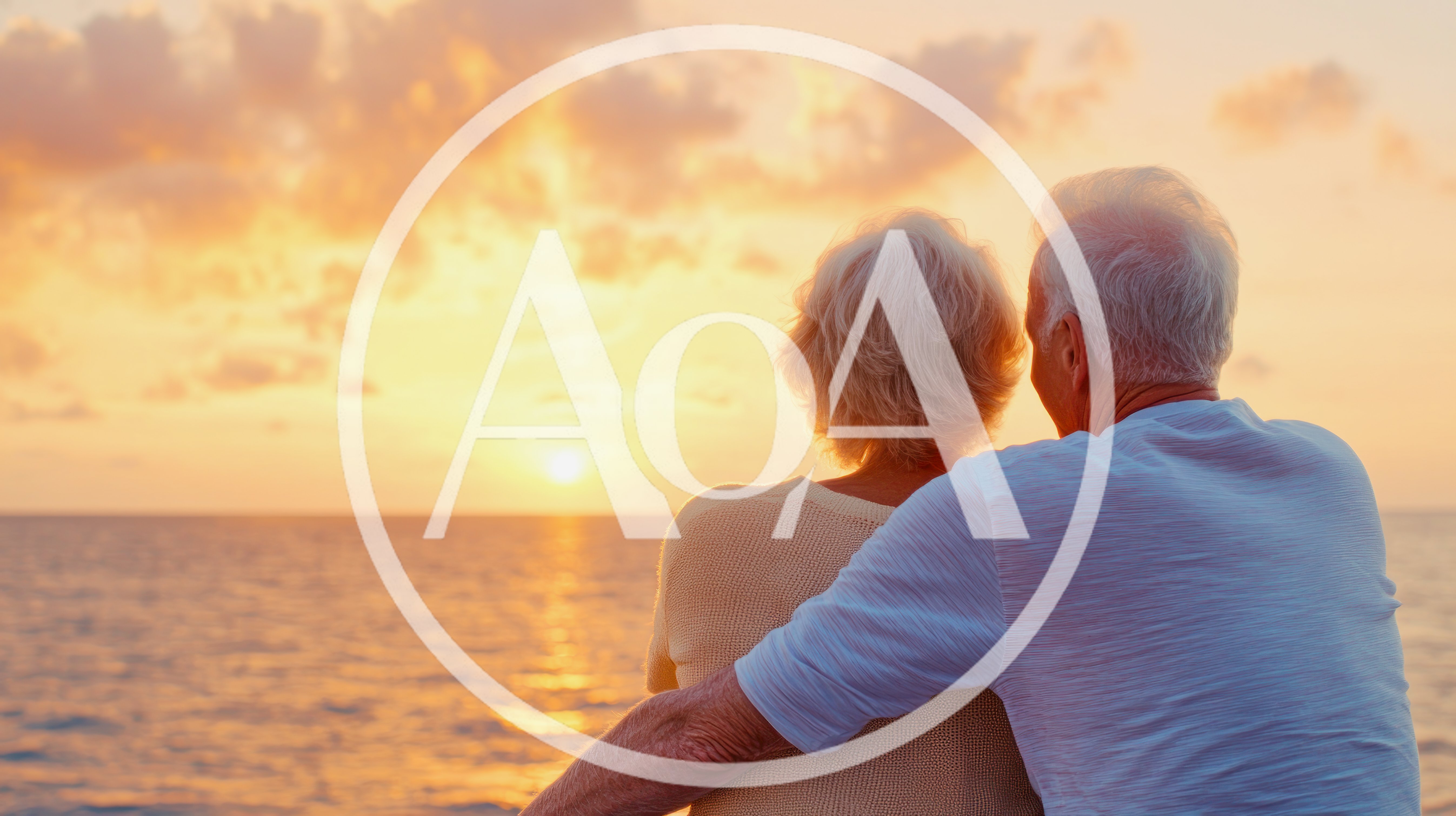Elderly Couple Embracing While Watching Sunset Over Ocean