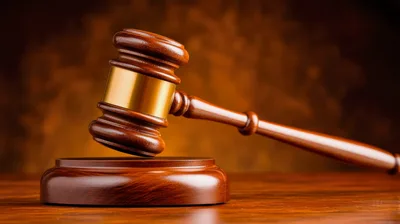 Wooden Judges Gavel Resting On A Sounding Block